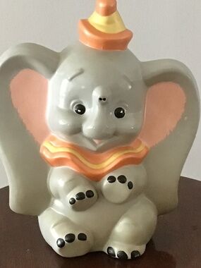 A vintage hand-painted ceramic Dumbo elephant figurine from Walt Disney Producti